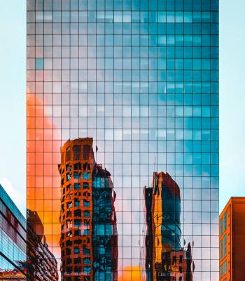 Tall glass building with orange reflection